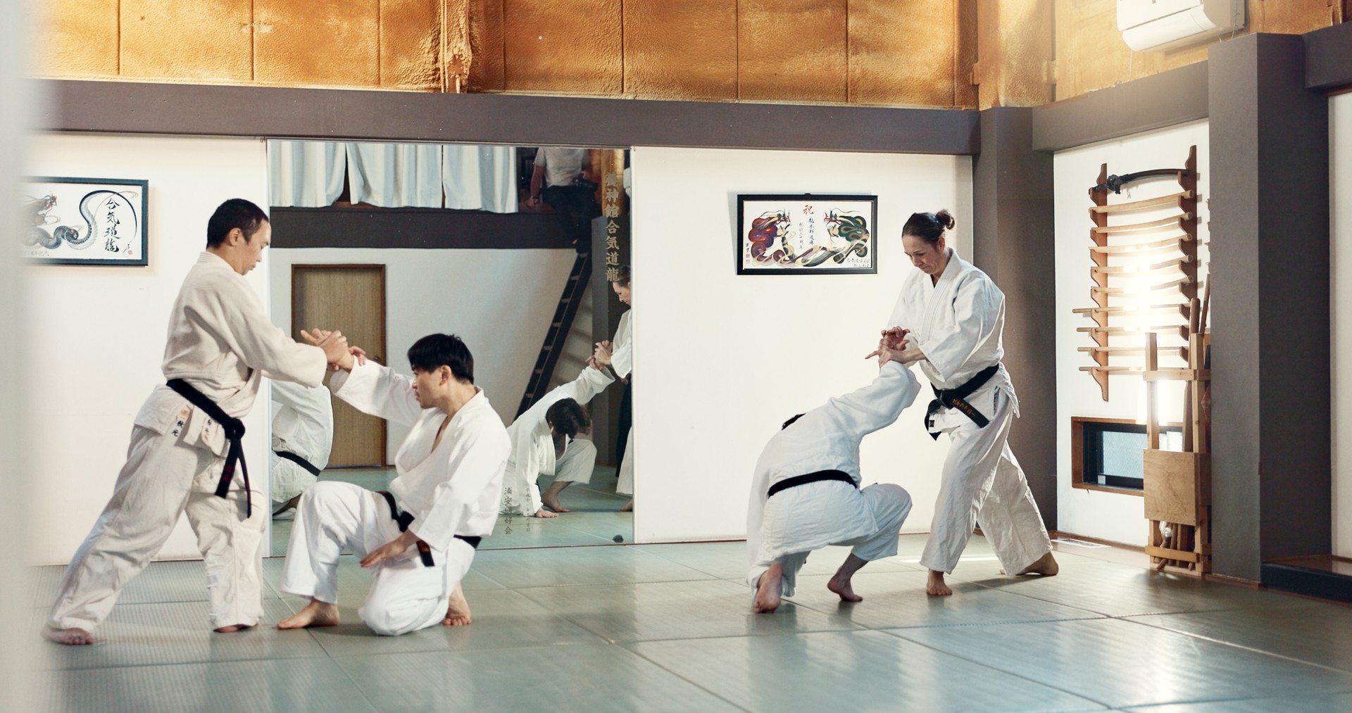 Students, karate or people learning in dojo for fitness, martial arts discipline or self defense combat. Demonstration, workout or kung fu master training athletes for fighting, education or class